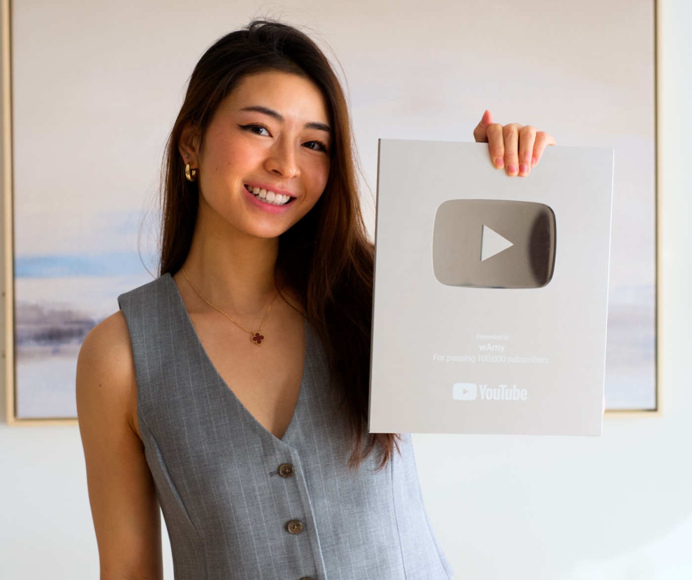 Amy Wang holding the YouTube Silver Creator Award