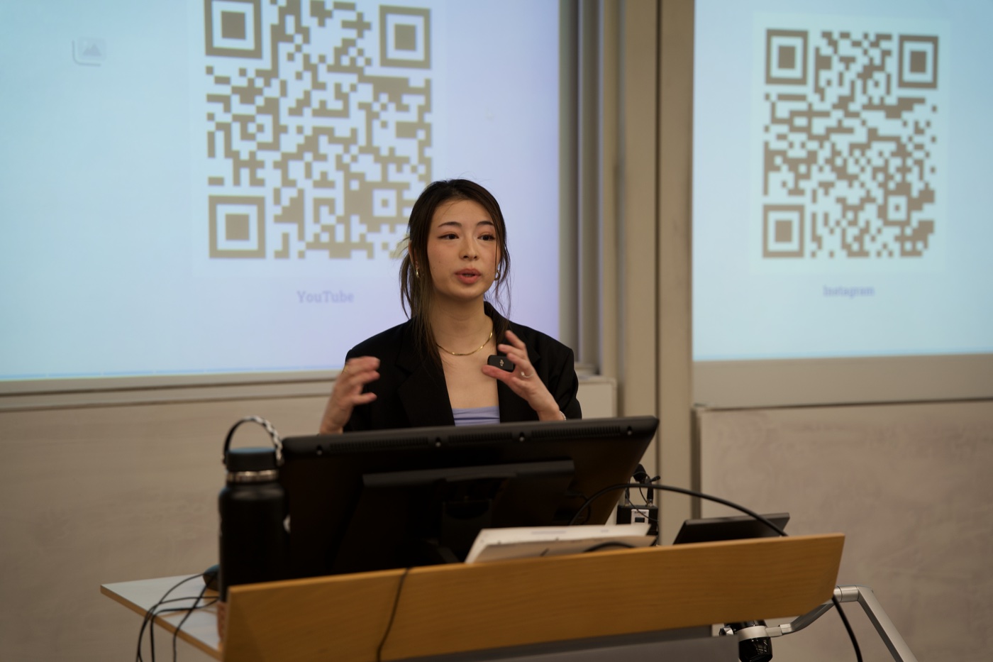 Amy Wang speaking at a podium